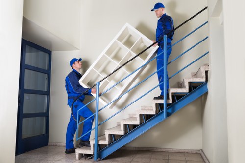 Professional movers loading furniture in Aldgate