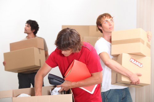 Packed boxes and moving equipment ready for collection in Aldgate