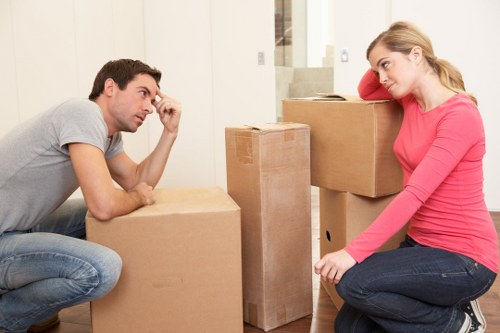 Movers transporting office furniture through a central London building