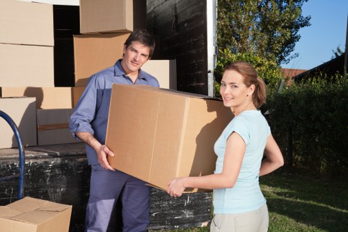 Mover lifting boxes carefully during a house move